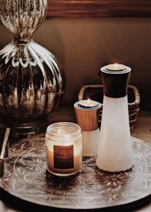 white and brown candle holders beside votive candle