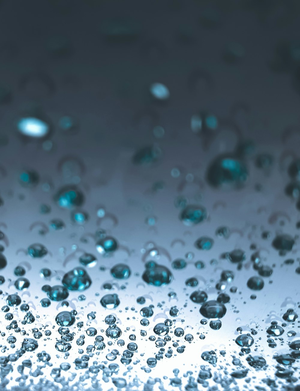 a close up of water droplets on a glass surface