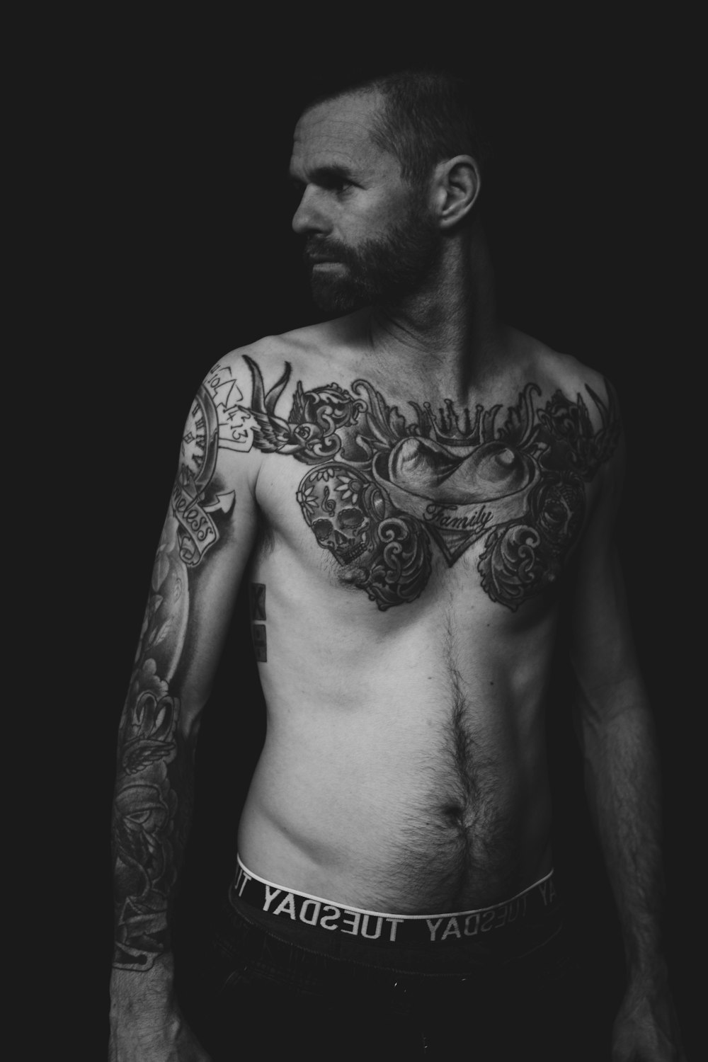 grayscale photography of topless man with tattoos