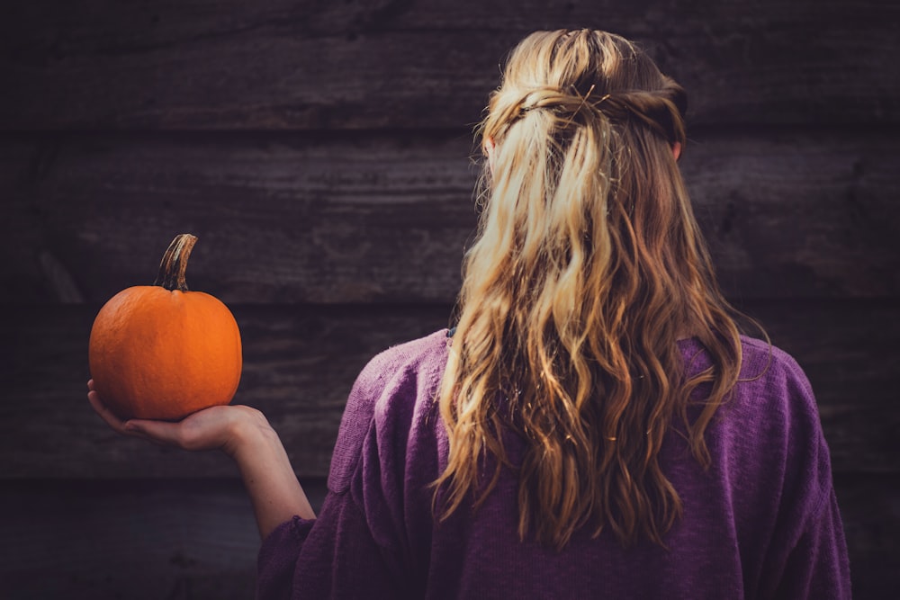 woman holding pumpkin