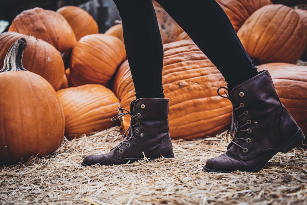 person standing near pumpkins