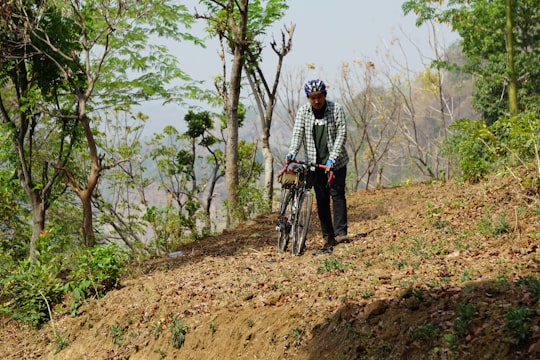 man holding road bike in forest in Mount Penanggungan Indonesia