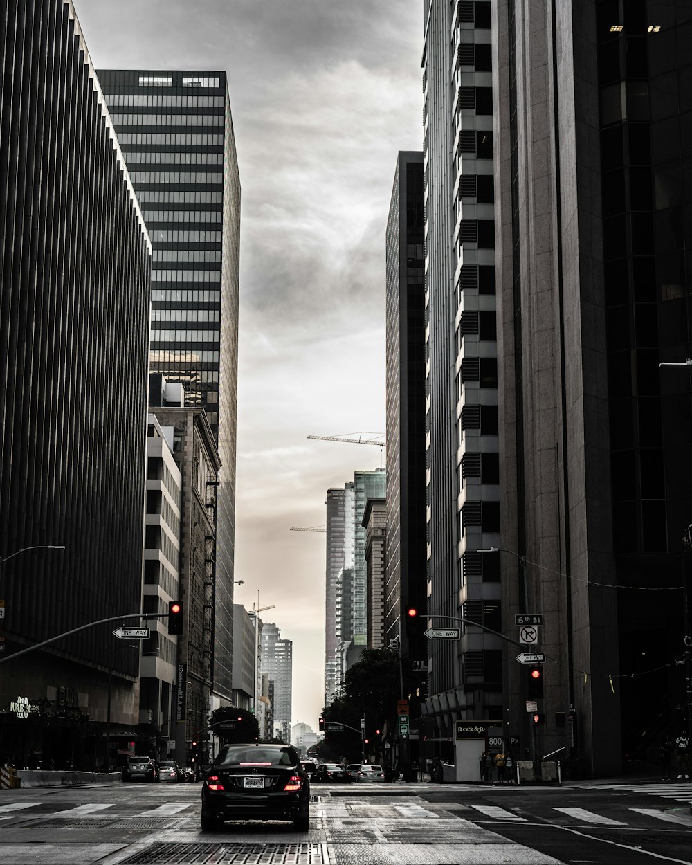 black car on road in city