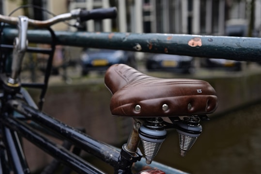 Close-up of a sleek, custom-fitted bike seat cover on a Royal Enfield.
