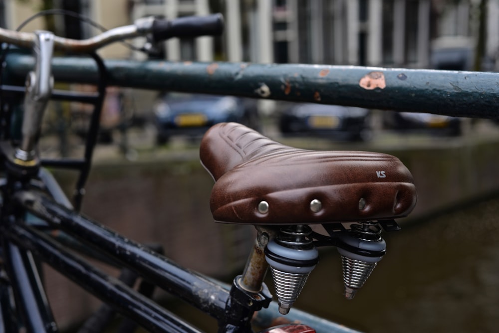 black bicycle parked near body of water