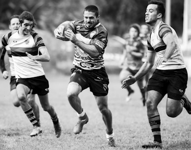 grayscale photography of men playing rugby