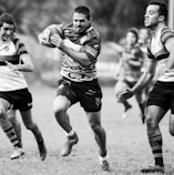 grayscale photography of men playing rugby