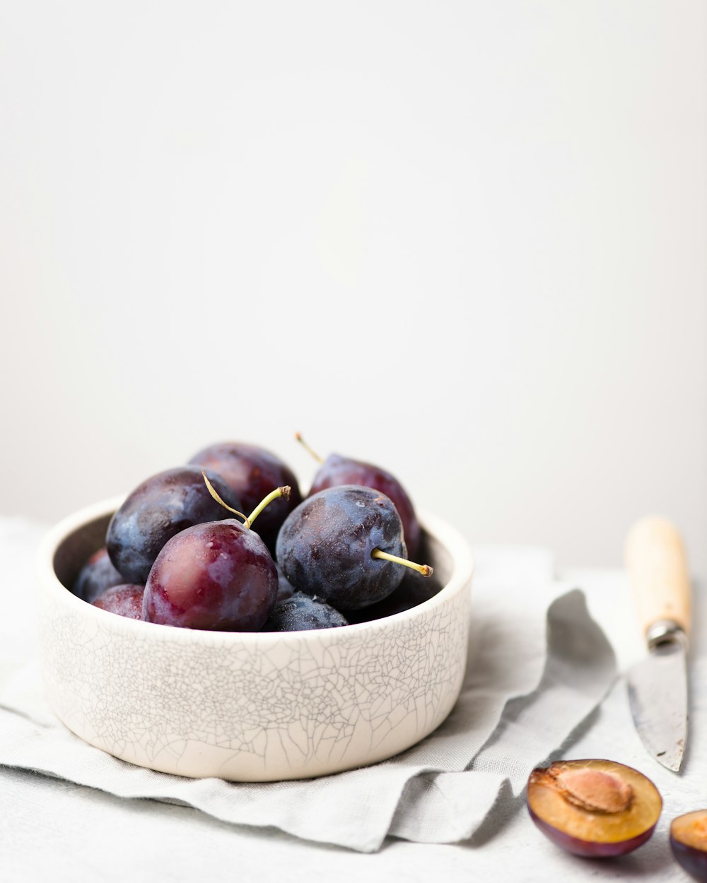 purple grapes on round white bowl