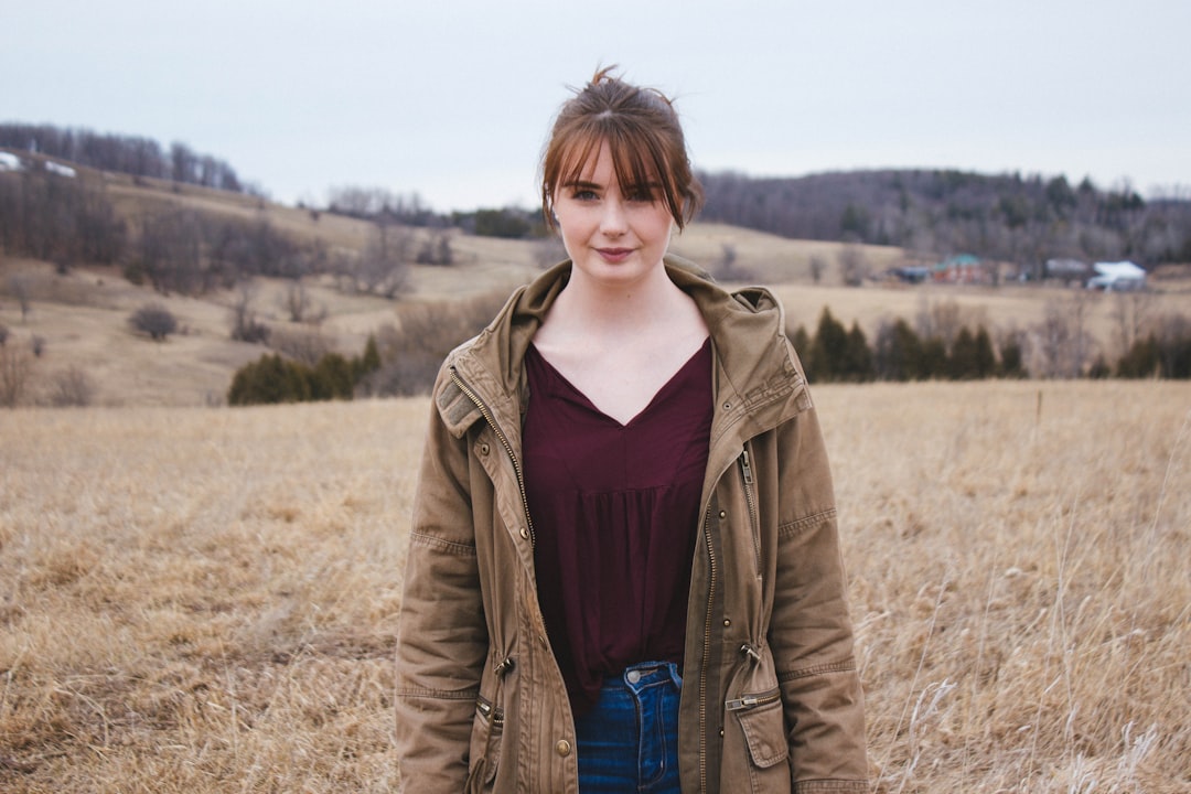 one unknown person wearing brown jacket during daytime