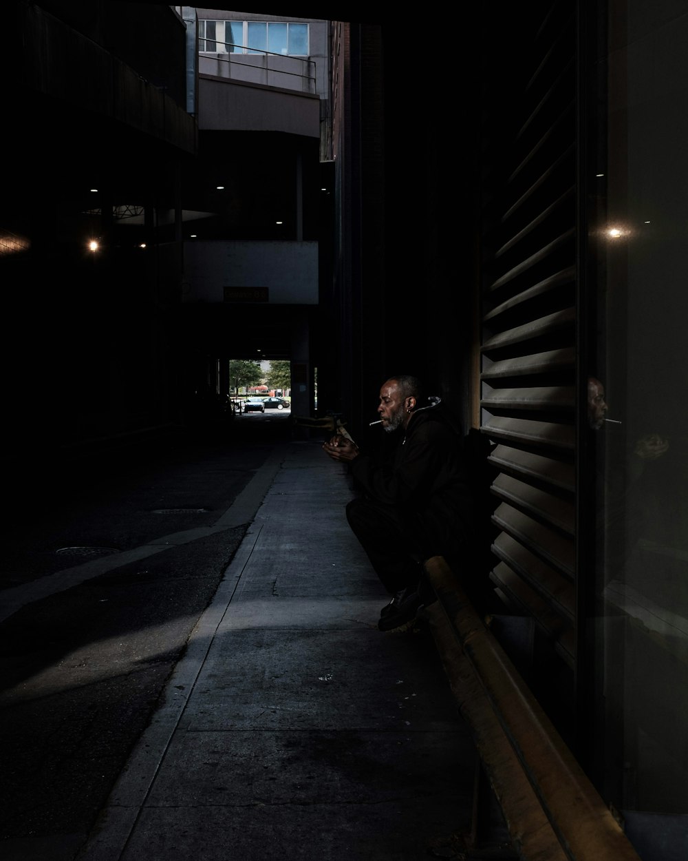 person sitting next to wall