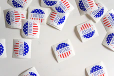Voted printed papers on white surface