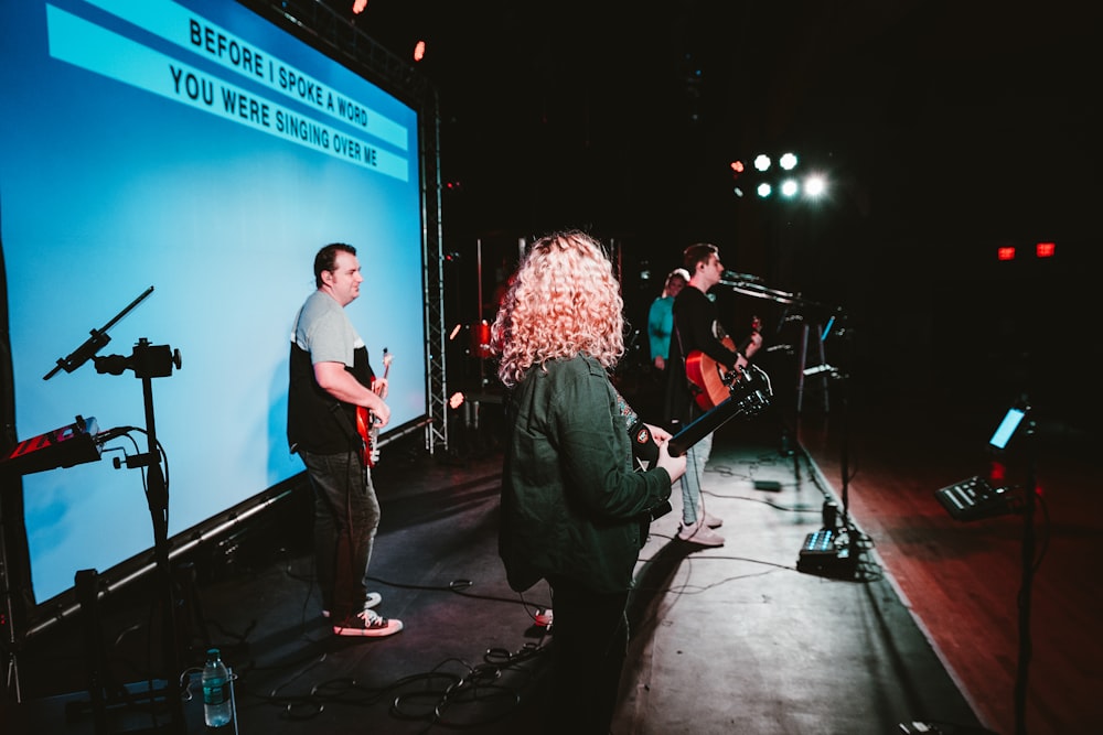 four person standing on stage