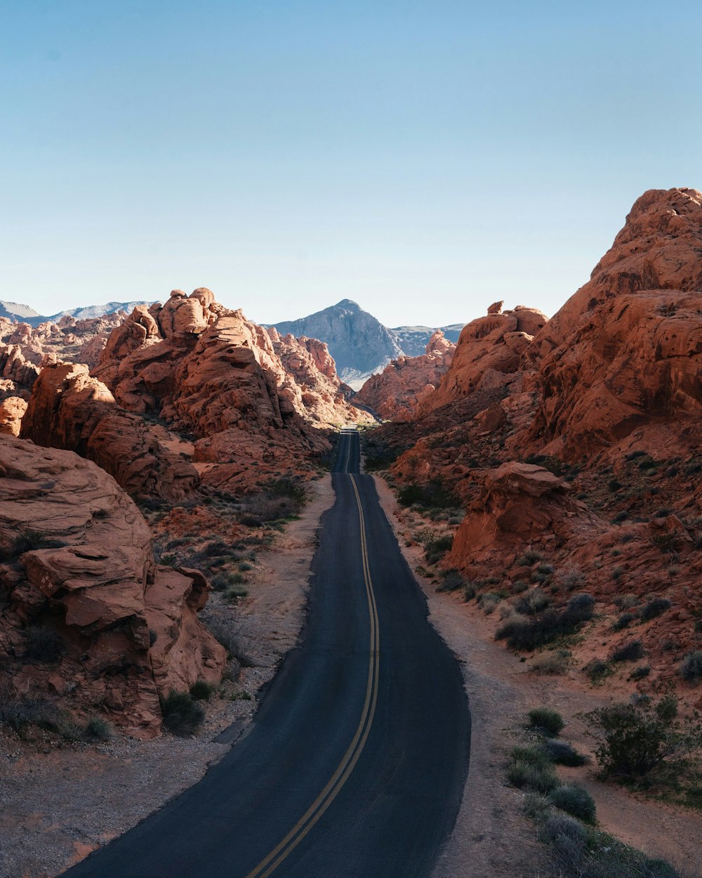 asphalt road between rocks