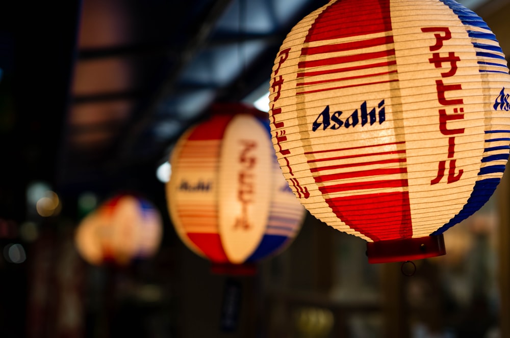 selective focus photography of white and red Asahi lantern