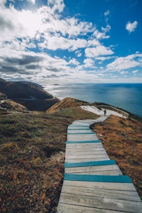 brow wooden stairs on cliff overlooking sea at daytme
