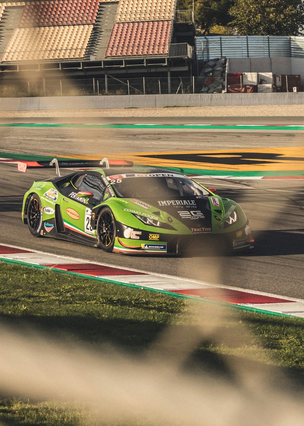 green and black Lamborghini race car on track during daytime