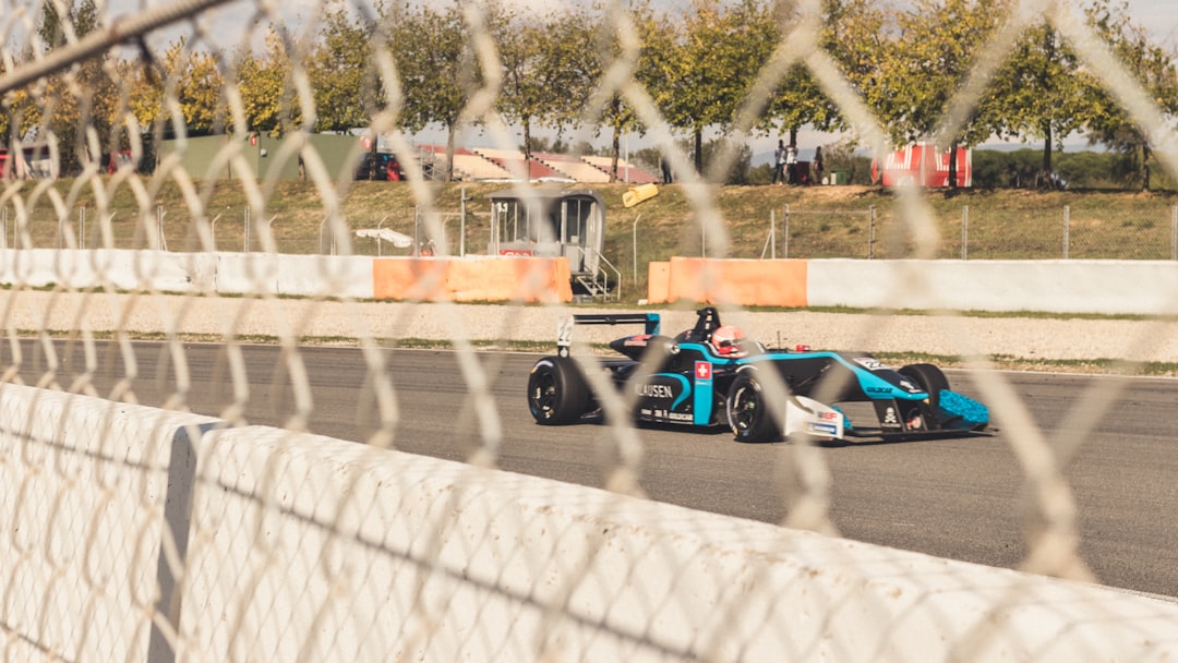blue and black race on track during daytimee,