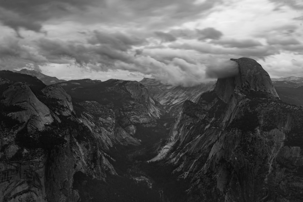 mountainous terrain under cloud formation