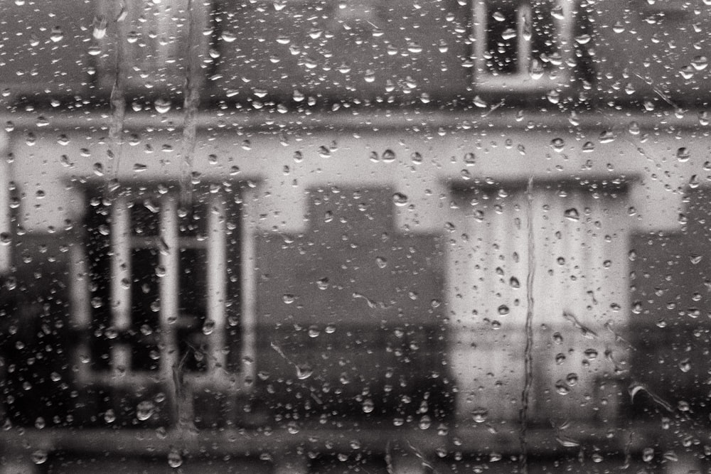 a black and white photo of rain on a window