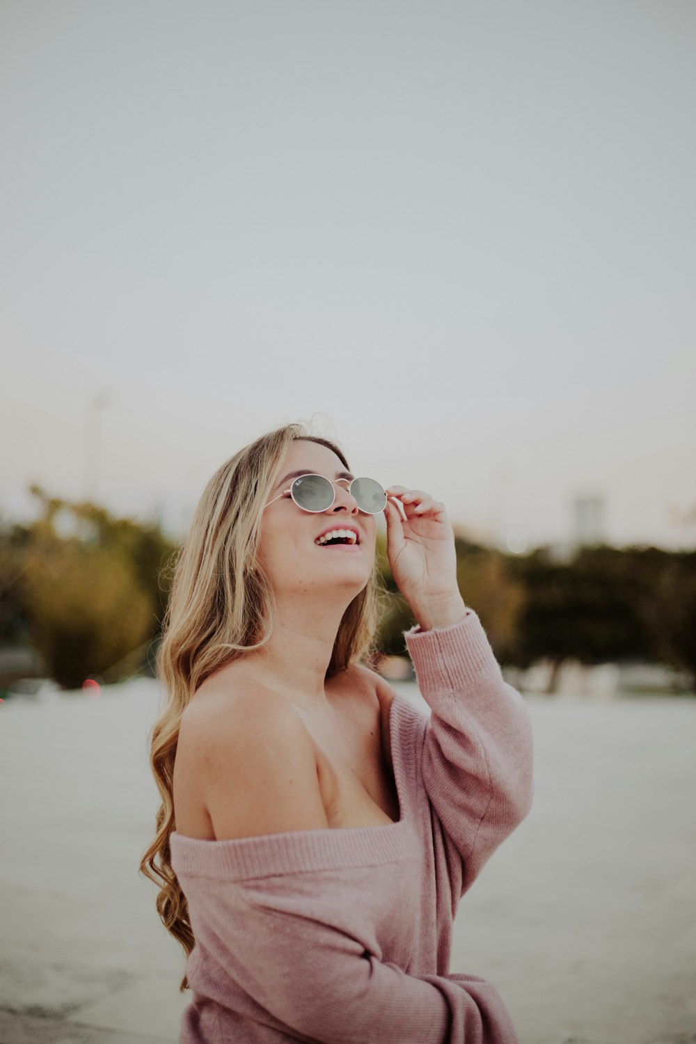 one unknown person wearing pink V-neck sweater during daytime