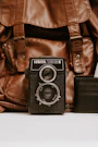 black Lubitel camera and brown leather bag