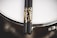 A close-up of a pair of drumsticks resting on a vibrant snare drum.