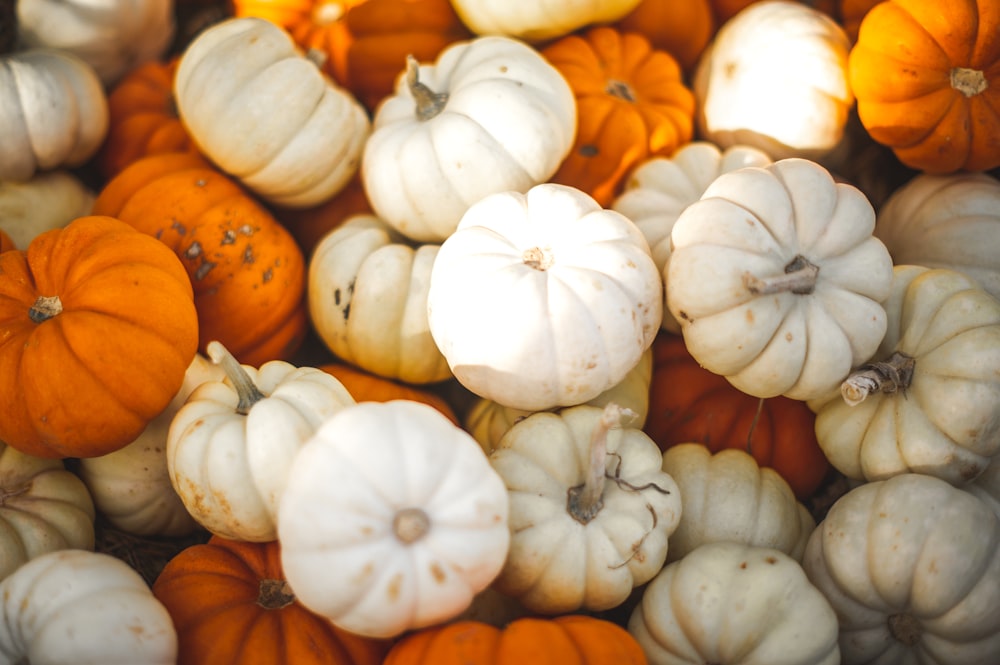 stacked white and orange pumpkins