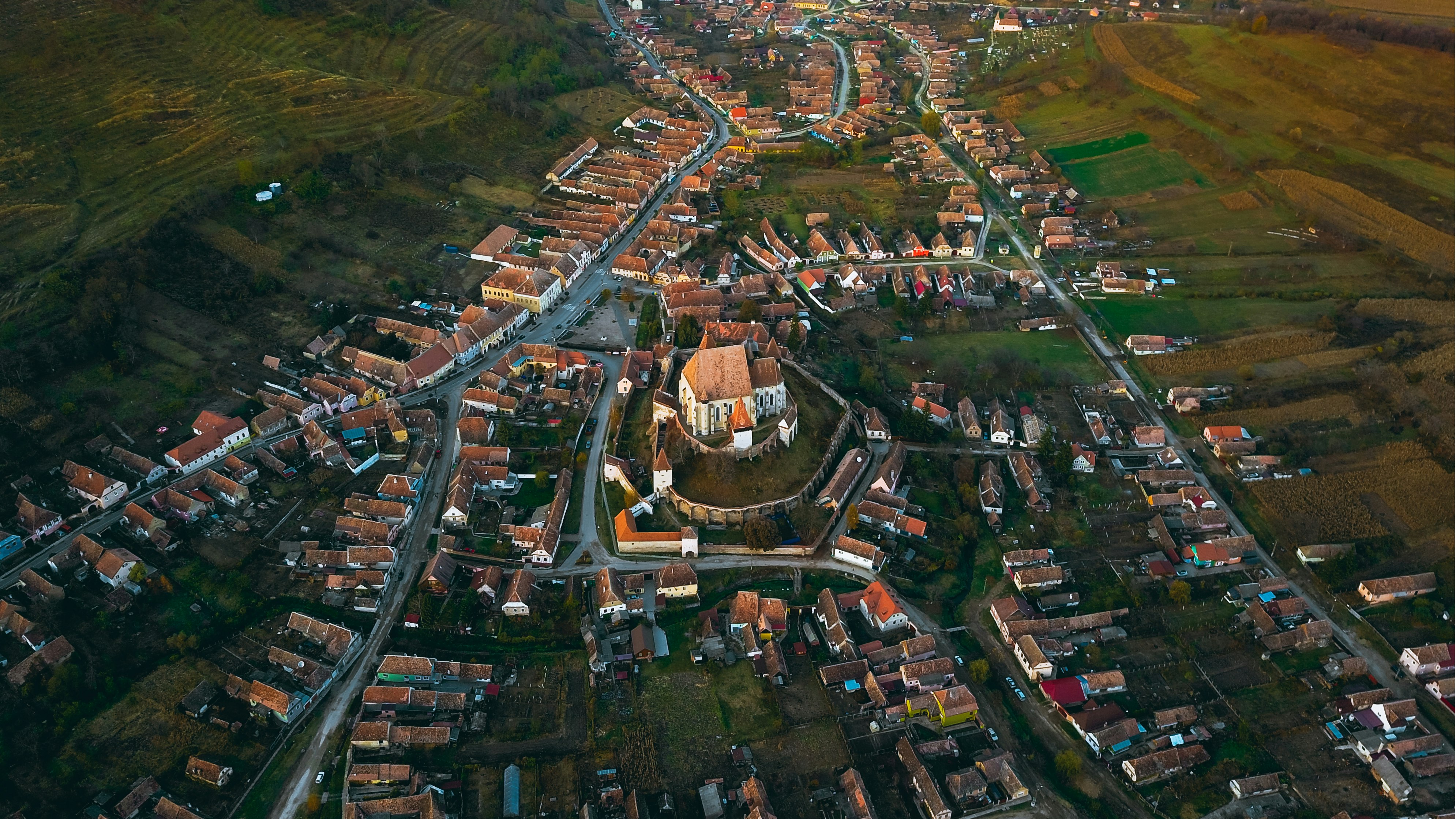 aerial photography of castle surrounded with houses during daytime