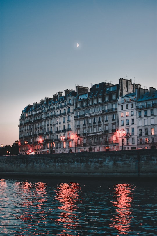 body of water and gray concrete building in Cathédrale Notre-Dame de Paris France