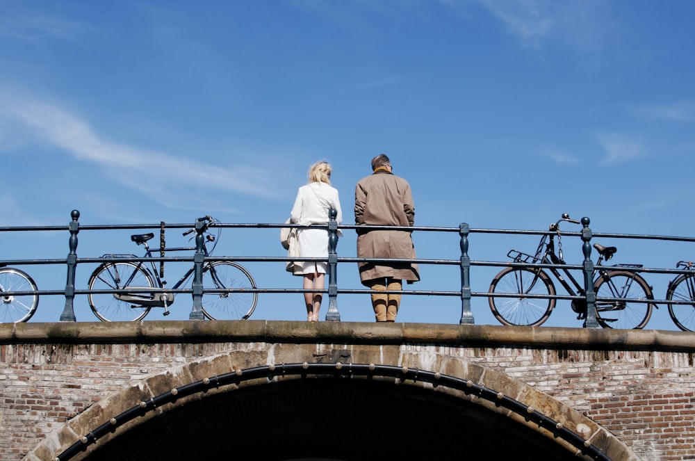 couple standing on bridge