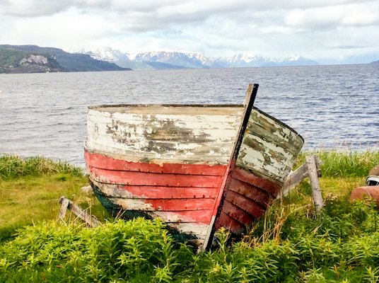 An old boat on the shore by the Rock Art Centre — Alta, Norway