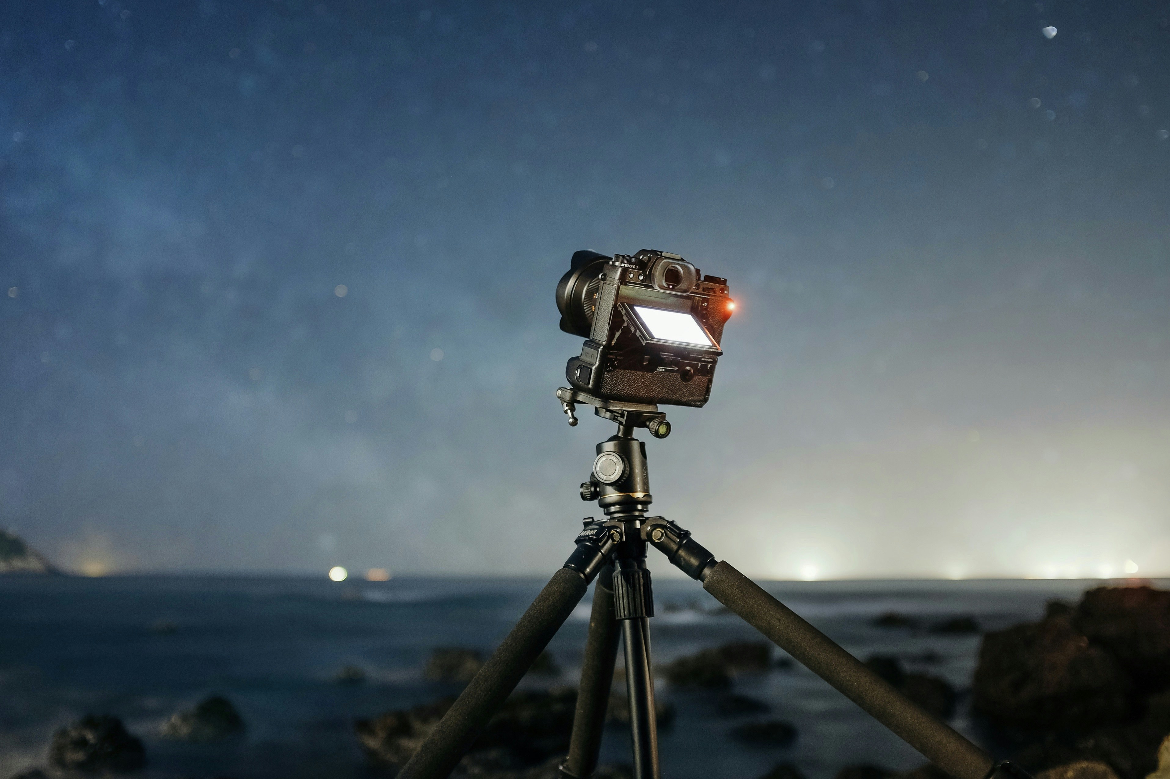 camera with tripod facing the stars during night time, Would you like to go see a star with me?