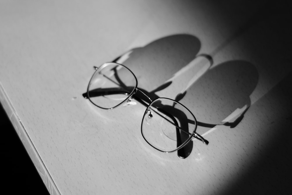 silver eyeglasses on table