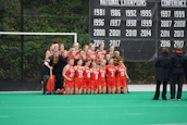 Group photo of the senior women's team celebrating a victory on the field.