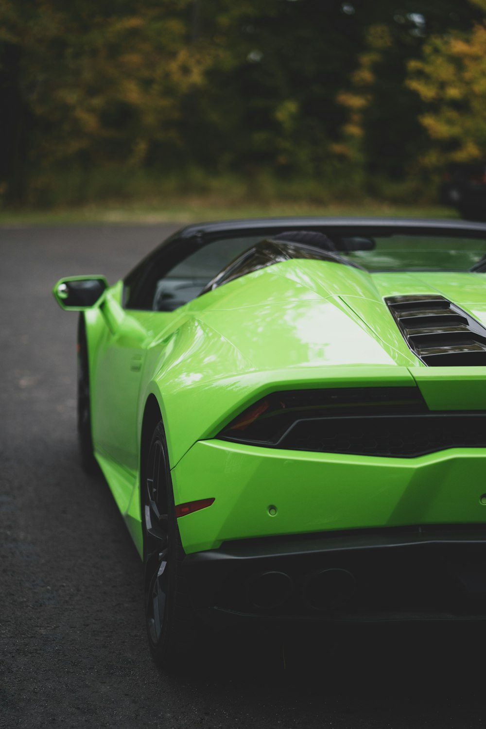 green and black convertible coupe parked outdoor