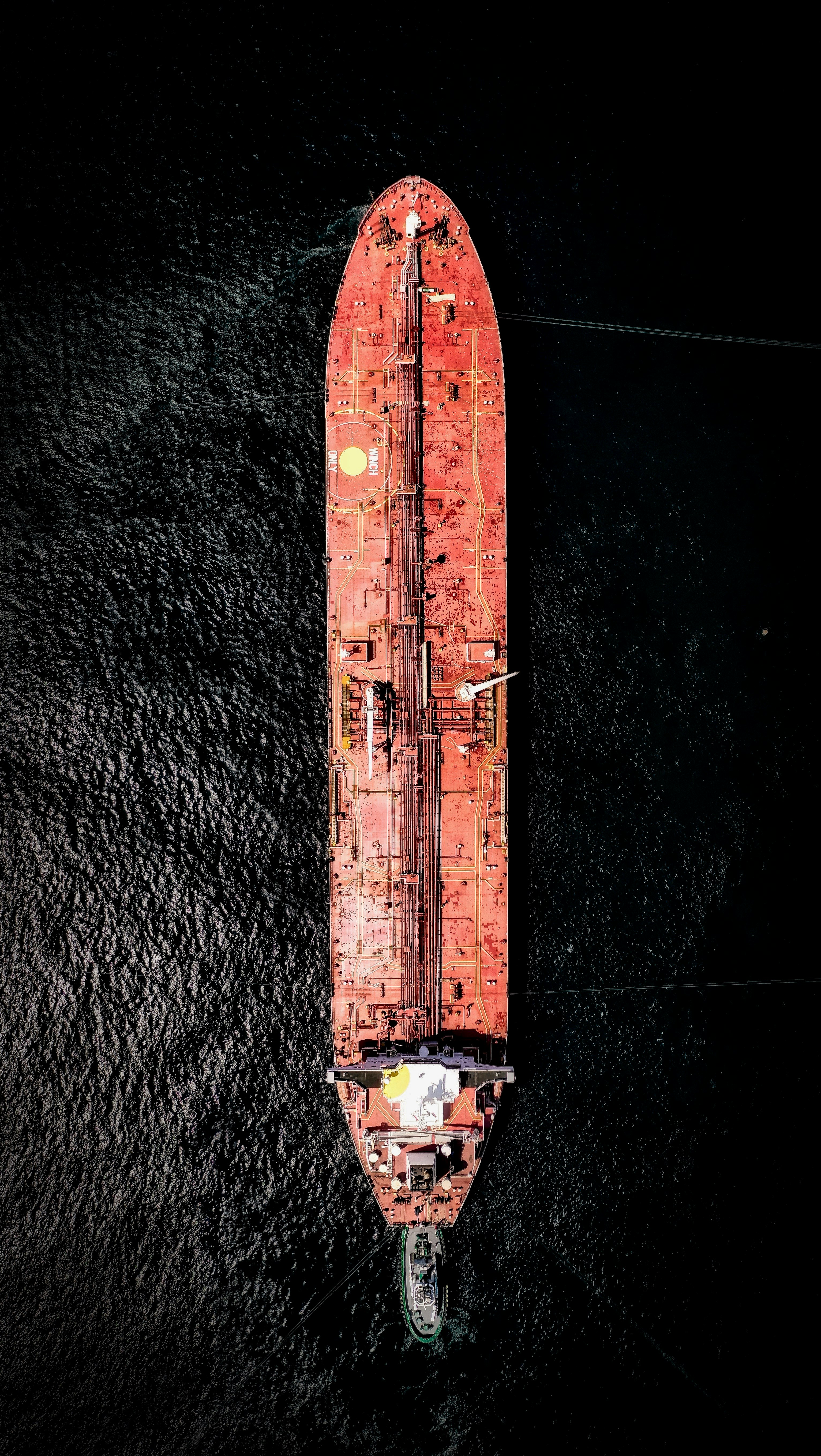 aerial photography of orange cargo ship on sea