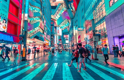 people walking on road near well-lit buildings japan google meet background