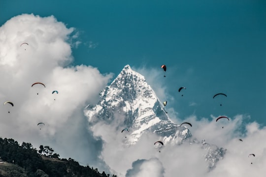 parachuting under blue sky in Pokhara Nepal