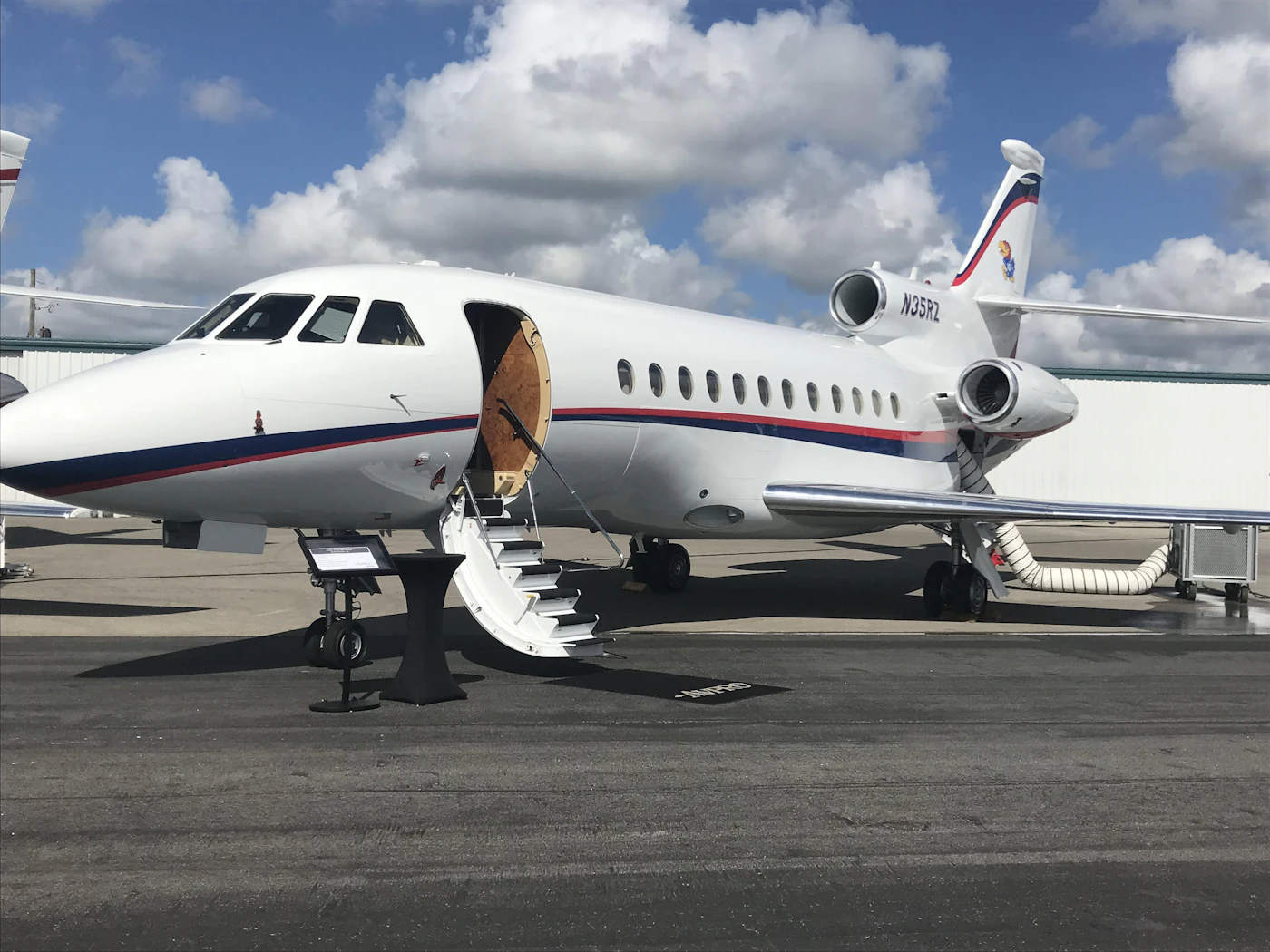 A midsize private jet with the airstairs down