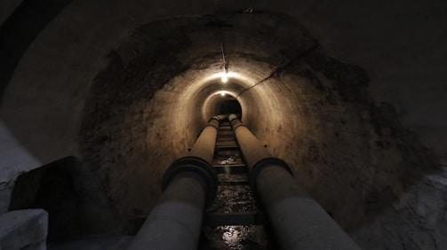 close-up of gray pipes on tunnel