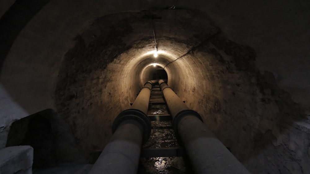 close-up of gray pipes on tunnel