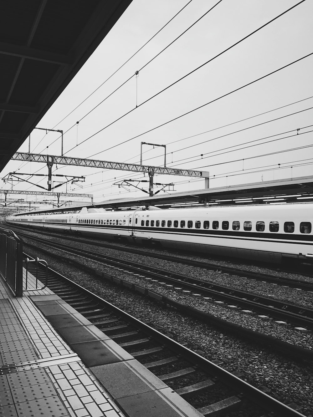 greyscale photo of train station