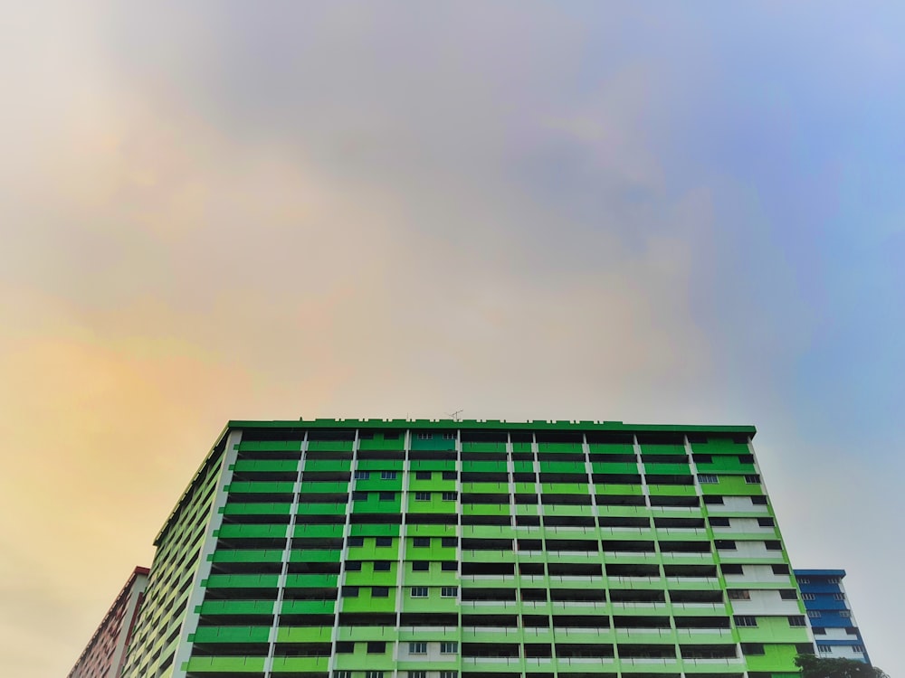 low-angle photo of green high-rise building