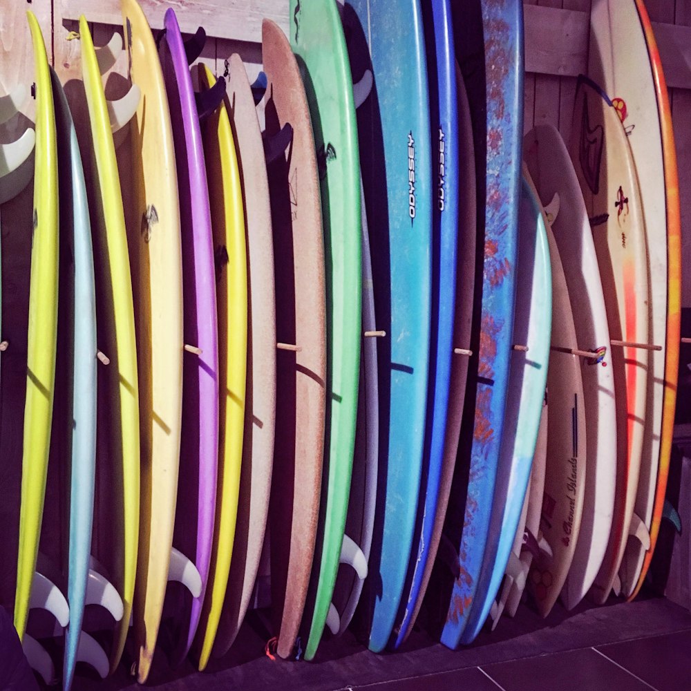 assorted color surfboards on rack