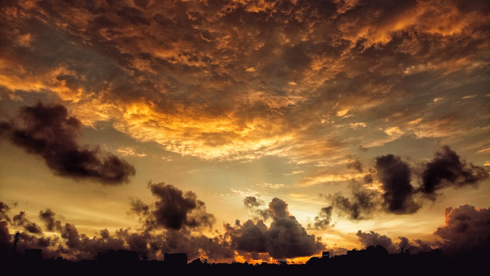 yellow clouds photo during golden hour