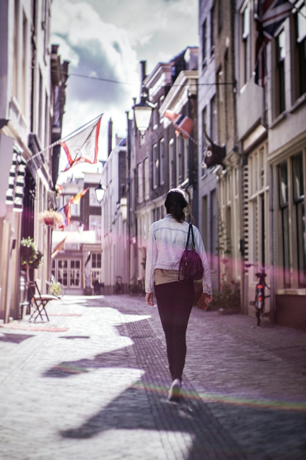 woman walking along buildings