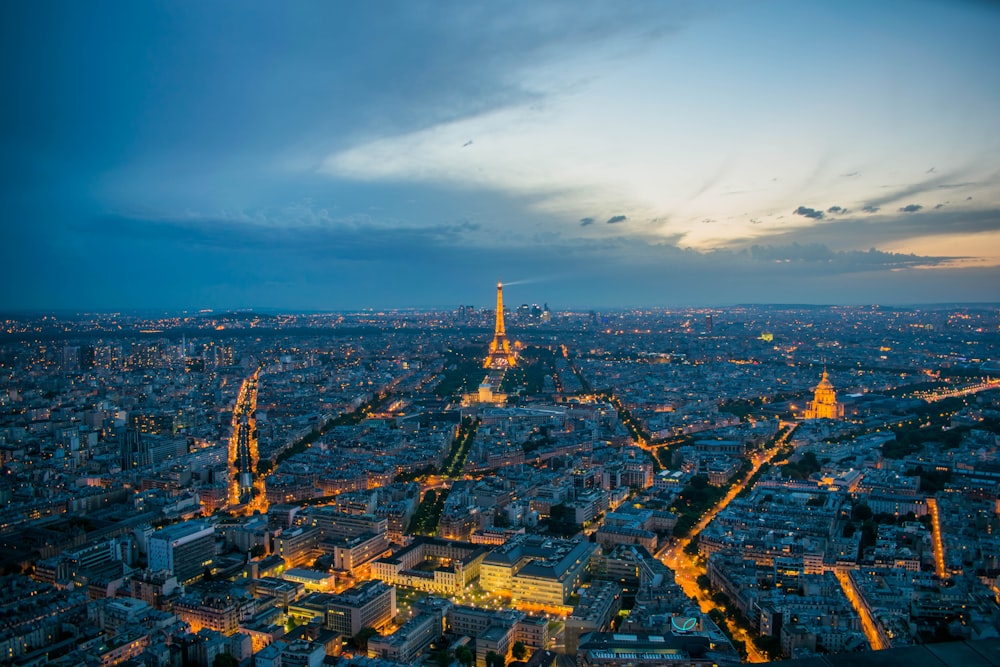 the eiffel tower is lit up at night