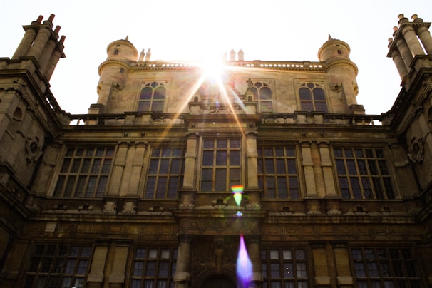 Sunlight streaming through stained glass windows illuminating the historic Carpenter Memorial Library facade.