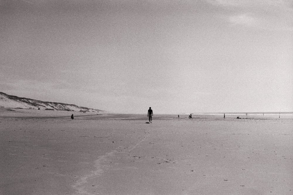 person walking on seashore