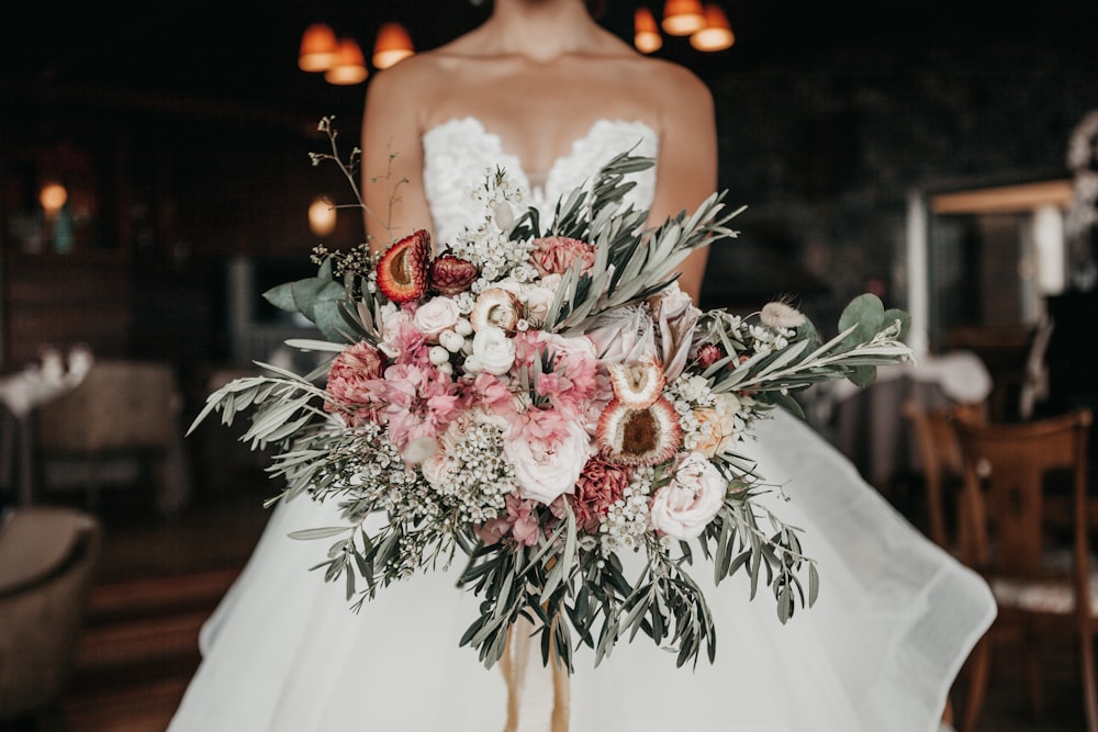 woman holding bouquet of flower